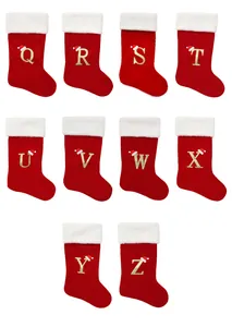 Close-up detailed view of red Christmas stockings featuring gold glitter letters Q to Z