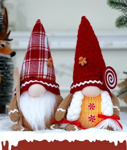 Close-up of a pair of festive gingerbread Christmas gnomes with knitted hats and braids