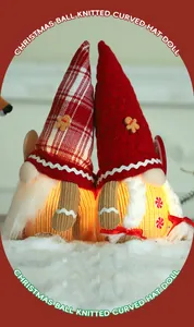 Close-up of glowing Christmas gnomes with knitted hats and gingerbread man accents