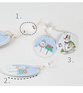 Detailed macro view of round ceramic snowman ornaments with beads and hemp rope.