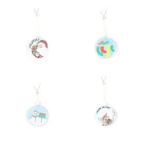 Detail view of circular ceramic Christmas ornaments with festive illustrations and hanging cords