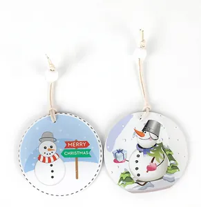 Close-up of round ceramic Christmas ornaments with cute snowman illustrations