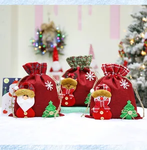 Close-up detail of festive red Christmas burlap gift bags with 3D Santa decorations
