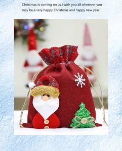 Close-up of a red burlap Christmas gift bag with Santa Claus and green tree decors