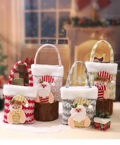Close-up of four festive sequined Christmas gift bags with Santa and Snowman