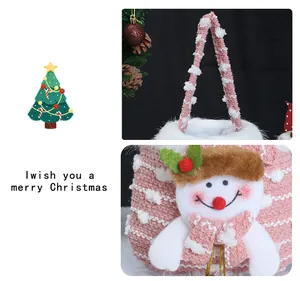 Close-up of a pink knit Christmas gift bag featuring a plush snowman character decoration