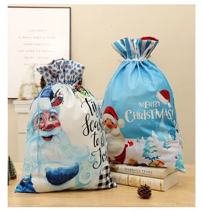 Detail view of large Christmas drawstring gift bags with Santa Claus prints
