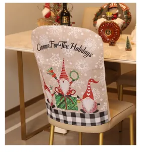 Detailed view of linen Christmas chair cover featuring gnomes and festive snowflake design.
