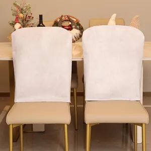 Set of two minimalist white Christmas chair covers used as festive dining room decorations.