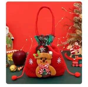 Festive red Christmas gift bag with a plush reindeer doll and snowflake patterns