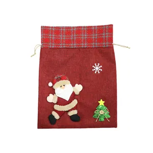 Large red burlap Christmas drawstring gift bag featuring plush Santa Claus and tree.