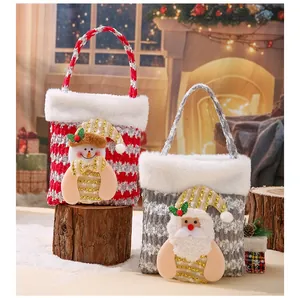 Festive Christmas gift bags featuring snowman and Santa Claus plush appliques in a cozy scene.