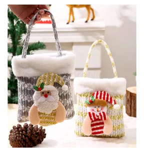 Detail view showing Santa and Snowman Christmas gift bags with plush white fur trim.