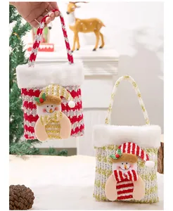 Two festive Christmas gift bags featuring plush snowman decorations on knit fabric