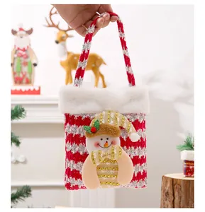 Detailed close-up view of a knitted Christmas gift bag featuring a cute 3D plush snowman