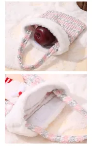 Detailed view of plush pink Christmas gift bag with velcro closure and fuzzy trim