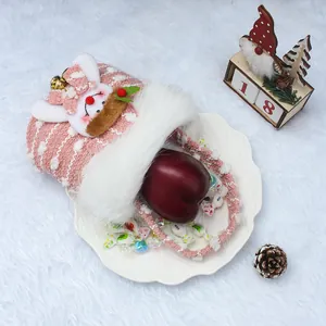 Pink knitted Christmas gift bag with reindeer decoration and plush trim for treats
