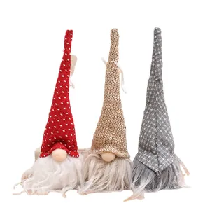 Three festive plush Christmas gnomes with tall pointed hats on a white background
