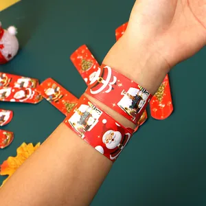 Detailansicht festlicher Weihnachts-Schnapparmbänder mit Weihnachtsmann am Handgelenk