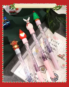 Close-up of four Christmas themed quicksand pens with glitter and festive silicone characters.