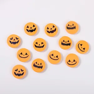 Close-up detail of small round Halloween pumpkin erasers with diverse facial expressions