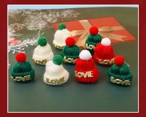 Close-up detail of mini Christmas knitted hats in festive red, white and green colors.