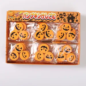 Detailed view of Halloween pumpkin erasers set in a themed display box