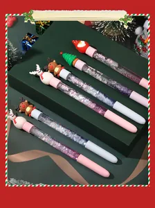 Detailed view of Christmas quicksand pens with festive toppers and colorful glitter barrels