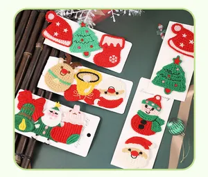 Vue détaillée de pinces à cheveux de Noël en tricot avec motifs Père Noël et sapin