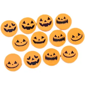 Close-up detail of Halloween pumpkin erasers with various printed Jack-o'-lantern faces.
