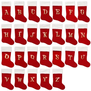 Large red Christmas stockings featuring golden embroidered alphabet letters A to Z design