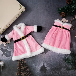 Festive pink velvet Christmas wine bottle covers with white fur trim and black belt