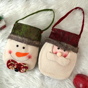 Creative Christmas gift bags with cute snowman and Santa designs on white fur rug.