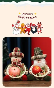 Detail of festive snowman and Santa Claus plush candy baskets for holiday treats
