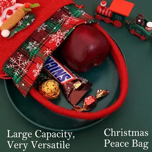 Christmas felt gift bag with plaid trim and snowflakes, holding apple and candies