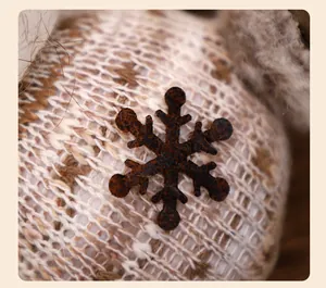 Close-up detail van een bruin sneeuwvlokornament op een gebreide kerstknuffel
