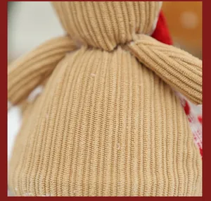 Detailed view of the tan corduroy fabric texture on a gingerbread man plush ornament