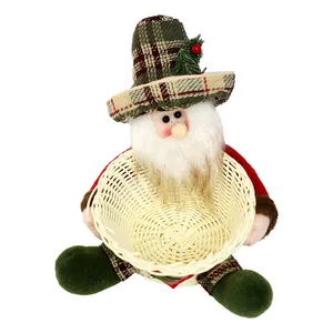 Santa Claus plush toy holding a woven candy basket for Christmas table decoration