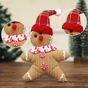 Festive gingerbread man plush doll with red Christmas hat for holiday tree decoration.