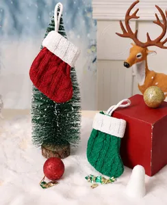 Dettaglio ravvicinato di mini calze di Natale lavorate a maglia rosse e verdi per albero