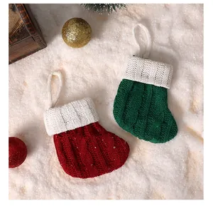 Detailed macro view of mini knitted Christmas stocking ornaments in red and green
