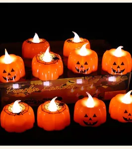Set of orange Halloween pumpkin LED candles with glowing flame for festive party decor