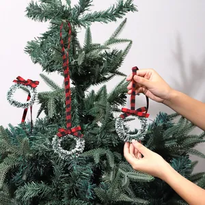 Mini Christmas tinsel wreath ornaments with red buffalo plaid bows on green tree