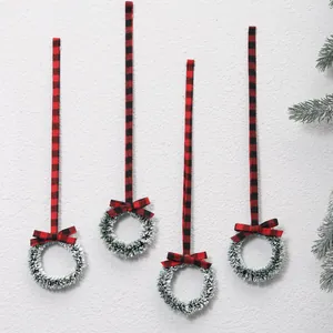 Set of 4 mini Christmas wreaths with red and black buffalo plaid ribbons on white wall