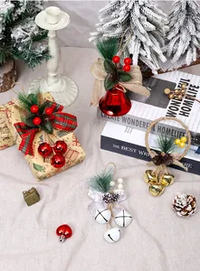 Close-up of festive Christmas bell ornaments with pine cones, bows and red berries