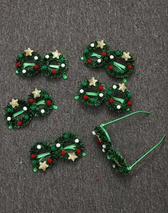 Detailed view of Christmas wreath glasses frames with tinsel, pom-poms, and stars.