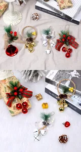 Detail view of Christmas tree hanging ornaments with bells, bows, and pine cones.