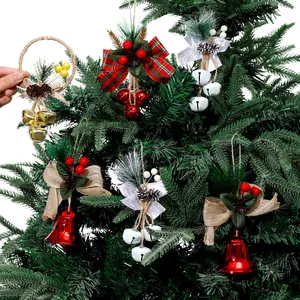 Diverse Christmas tree bell ornaments featuring bows and berries on a lush green Xmas tree