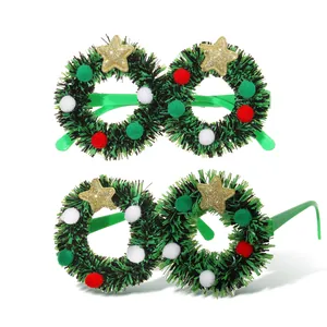 Festive Christmas wreath party glasses frames decorated with gold stars and colorful pom-poms.