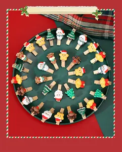 Detailed view of assorted Christmas-themed wooden clips with colorful cartoon figures